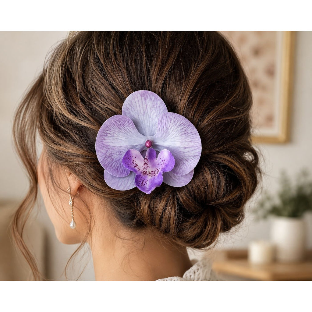 A purple orchid hair accessory pinned to the back of a woman's brown updo hairstyle, shown from a side-back angle.