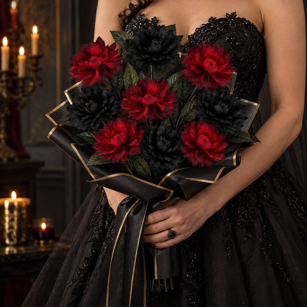 A bouquet of artificial flowers with alternating deep red and black peony-like blooms, wrapped in black ribbon with gold trim, held by a person wearing a black embellished gown in a dimly lit indoor setting with candles.