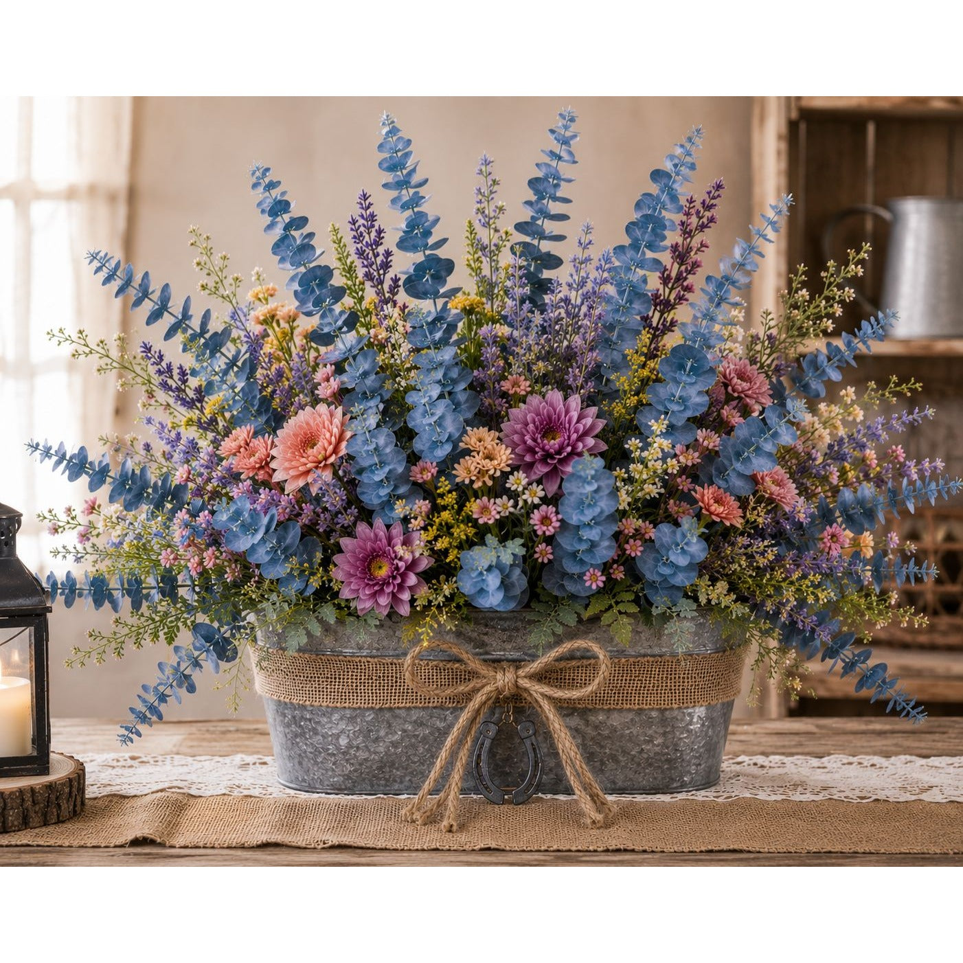 Bouquet of flowers in a metal container with burlap ribbon on a table.