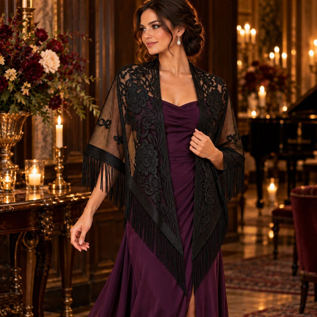A woman stands in an elegant indoor setting wearing a deep plum purple gown with a black lace and fringe shawl draped over her shoulders. The background features warm lighting from candles, a grand piano, and floral arrangements.