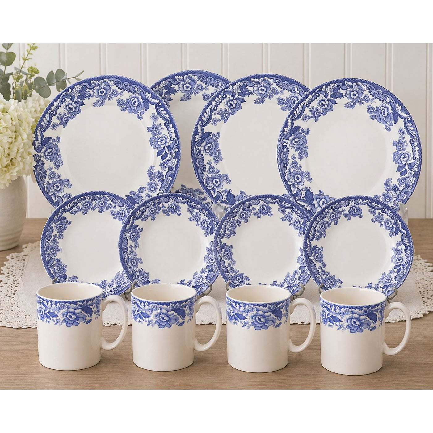 Spode Delamere Blue dinnerware styled on elegant table setting with blue hydrangeas crystal glasses and silver cutlery
