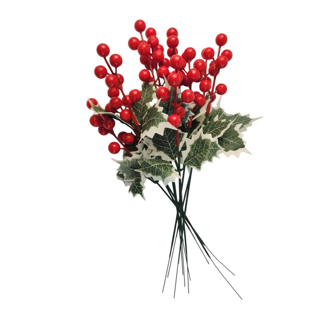 Artificial holly branch with glossy red berries and green variegated leaves on thin wire stems, isolated on a white background.