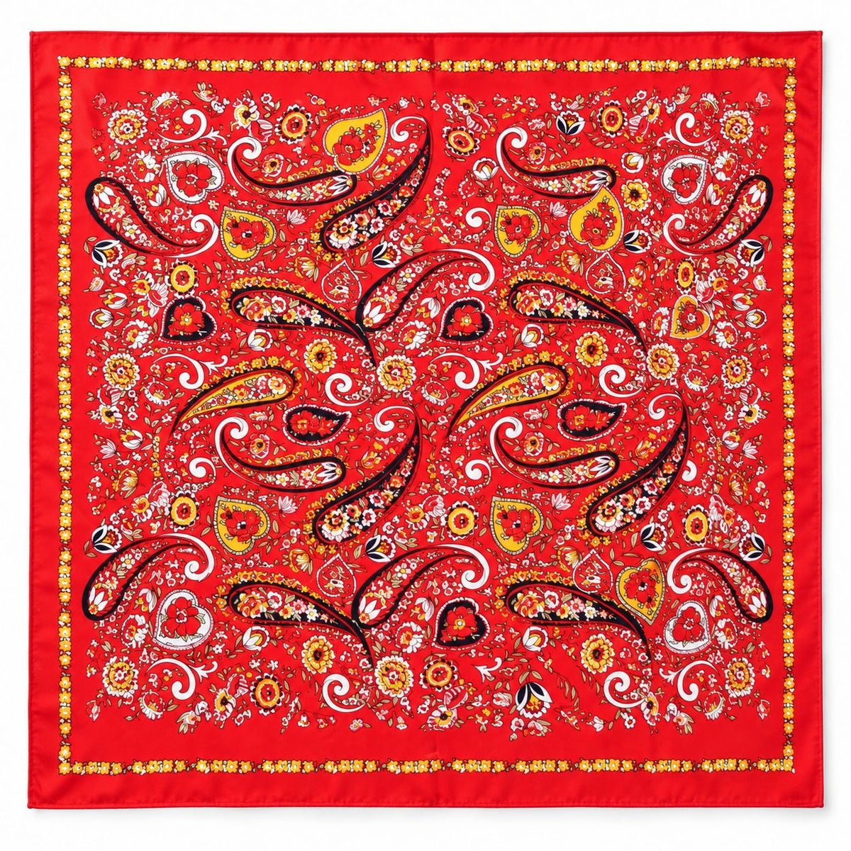 A square red satin scarf featuring an intricate paisley and floral pattern in yellow, white, black, and orange, finished with a decorative border.