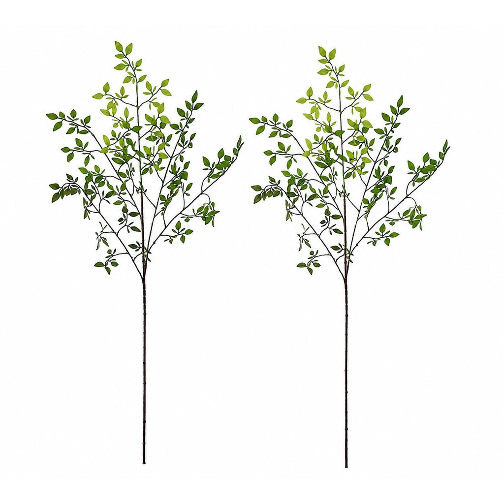 Two artificial green leafy branches on a white background