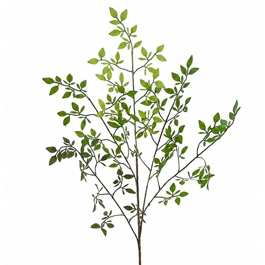 Artificial green leaf branch on a white background