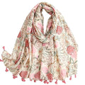 Floral patterned scarf with pink tassels on a white background
