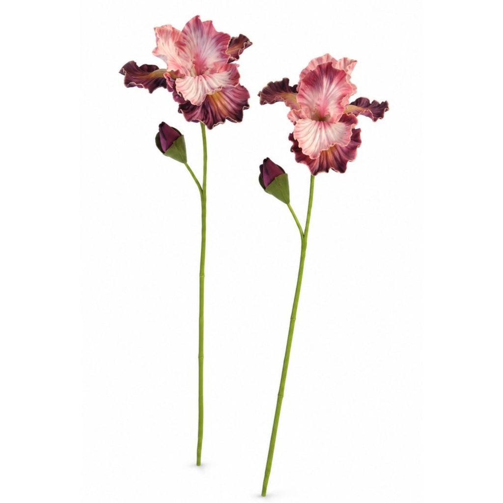 Two artificial iris flowers with pink and white striped petals, dark burgundy tips, and long green stems on a plain white background.