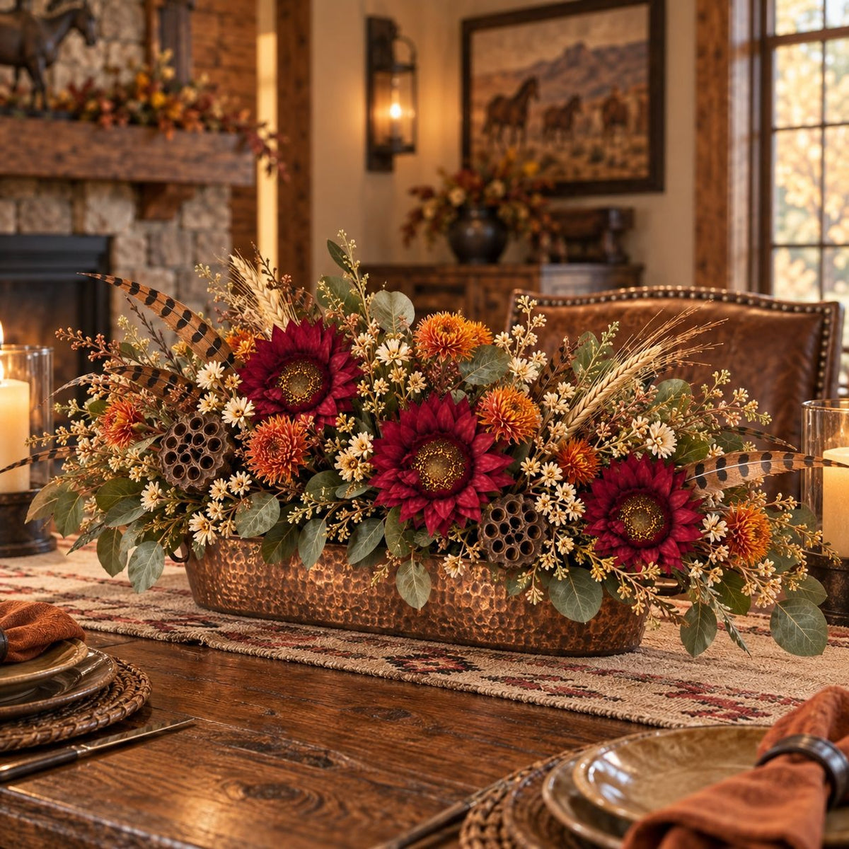 An autumn-themed floral centerpiece in a hammered copper rectangular planter, displayed on a rustic wooden dining table in a cozy, warmly lit living room setting.