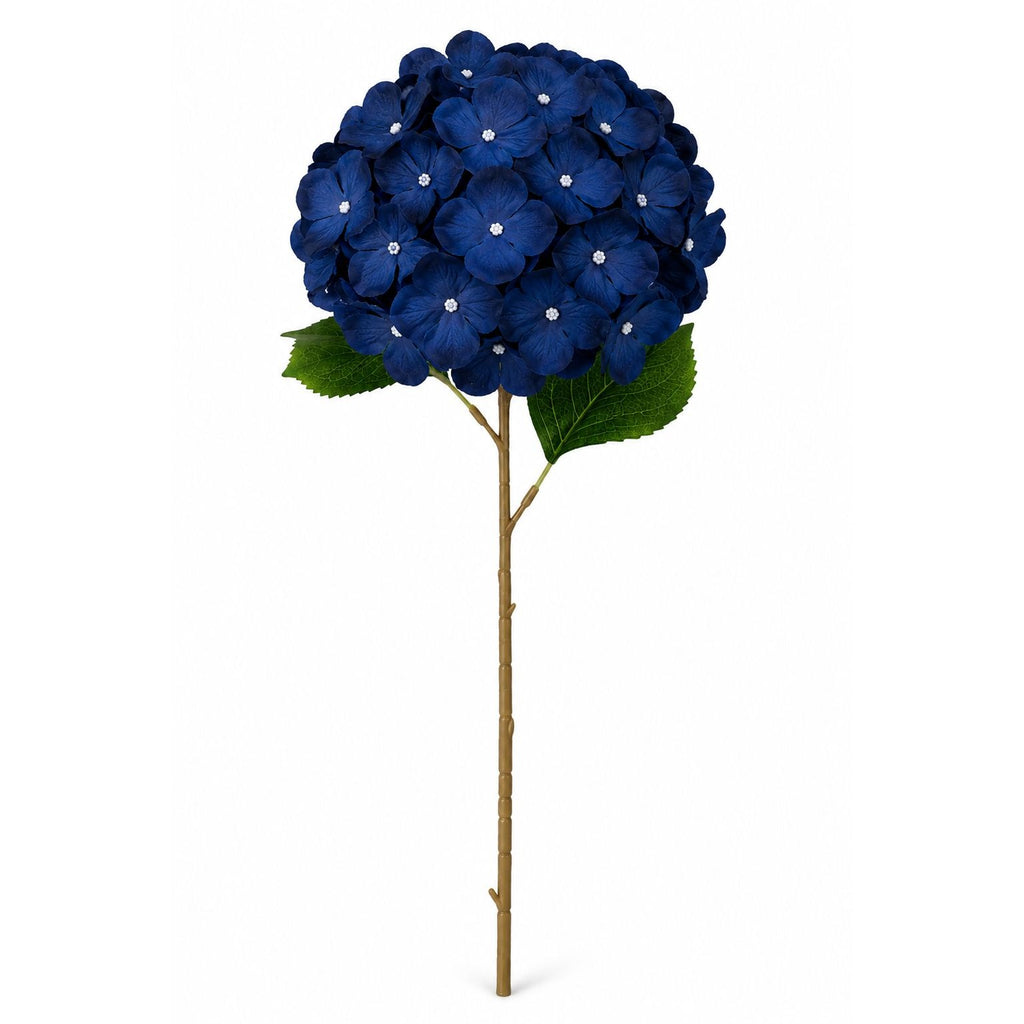 A single artificial hydrangea stem with a dense round cluster of deep blue flowers, green leaves, and a brown stem on a plain white background.