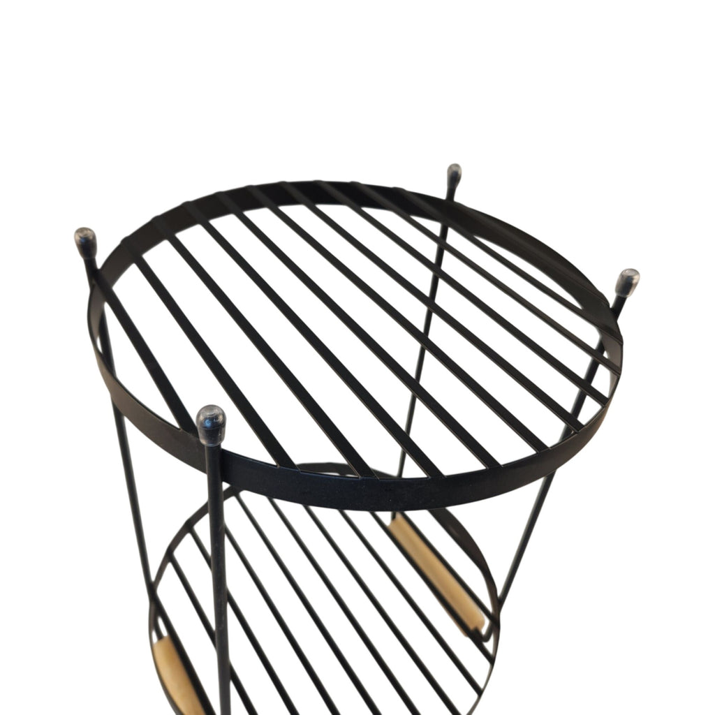 A black metal two-tier side table or shelf with a circular slatted top and bottom tier, shown against a plain white background.