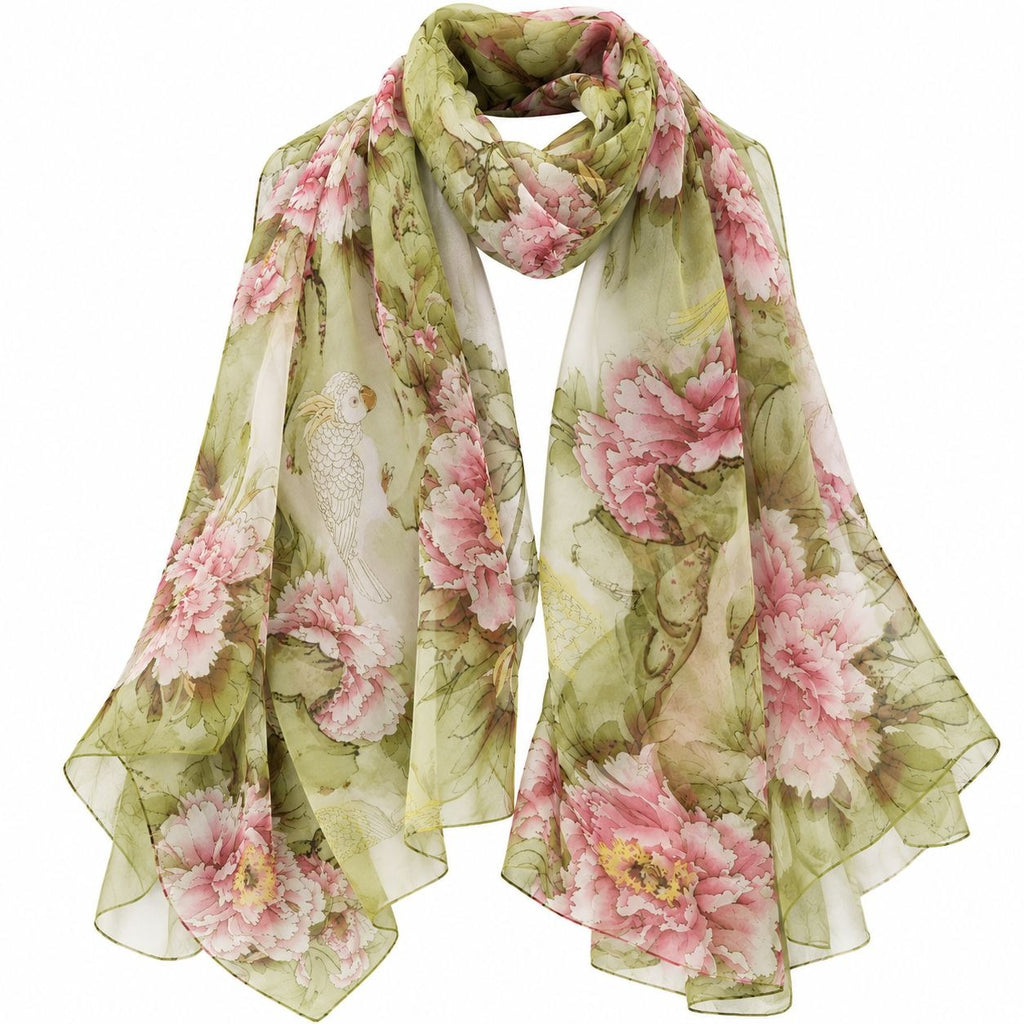 A lightweight sheer scarf with a pink peony and bird print on an olive green and cream background, draped against a plain white background.