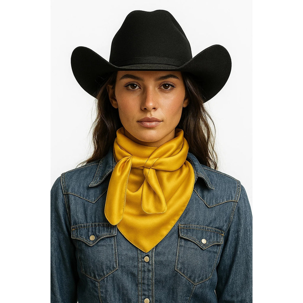 Person wearing a black cowboy hat, denim jacket, and yellow scarf on a white background