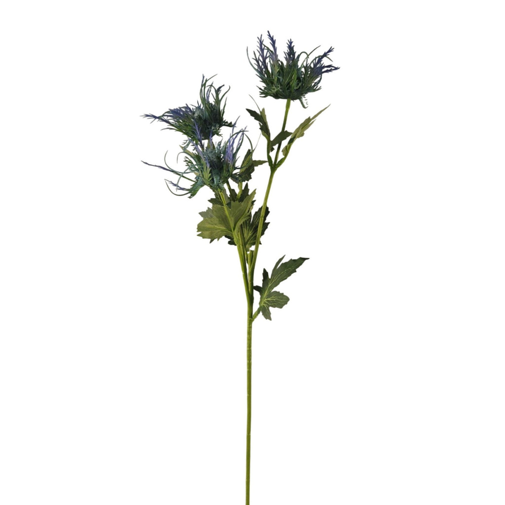 A single artificial flower stem with three blue-purple thistle-like blooms, green leaves, and a long green stem, isolated on a white background.
