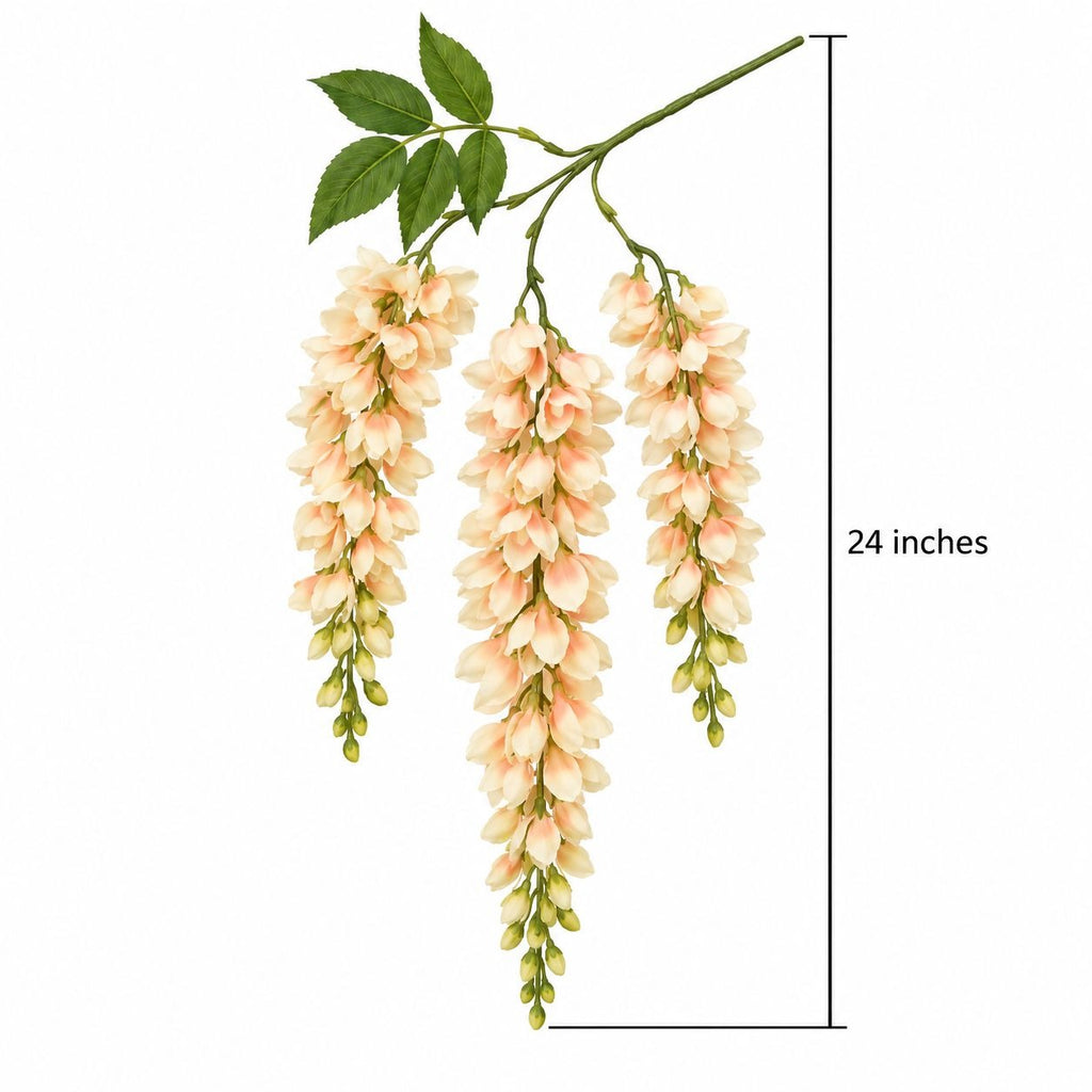 A wisteria-style artificial flower branch with three hanging clusters of pale peach and cream blossoms, green leaves, and a green stem, shown on a white background with a vertical measurement marker labeled 24 inches.