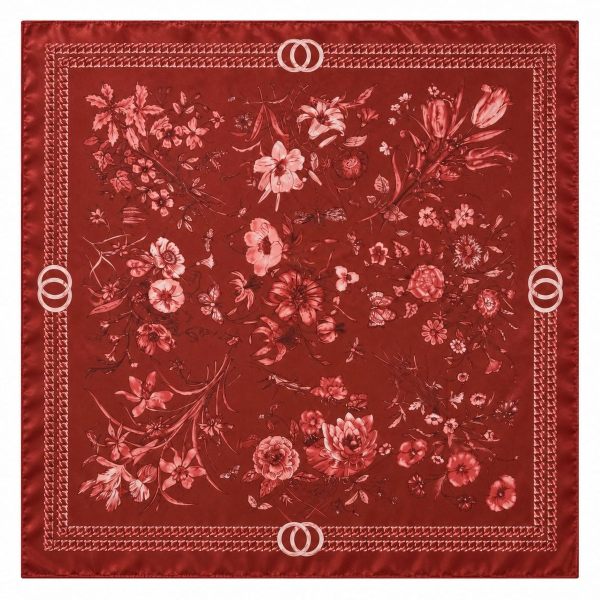 A square red silk scarf featuring an intricate floral pattern in shades of pink and red, finished with a decorative border and double-O logo details in the corners.