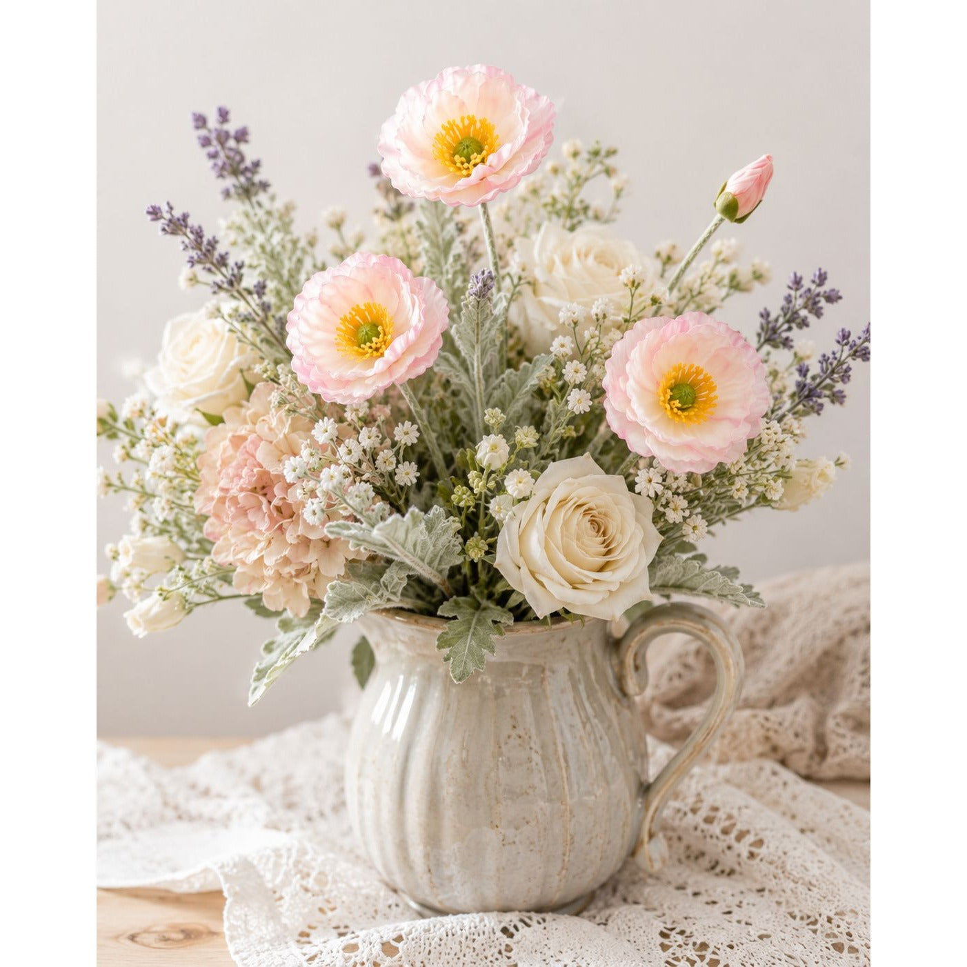 Floral arrangement in a ceramic pitcher on a lace tablecloth