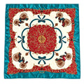 A square silk scarf featuring a classic vintage carriage pattern. The design has a vibrant turquoise blue satin border, a central cream-colored field, a large red medallion with gold detailing, and red carriage motifs with blue bows and gold scrollwork.