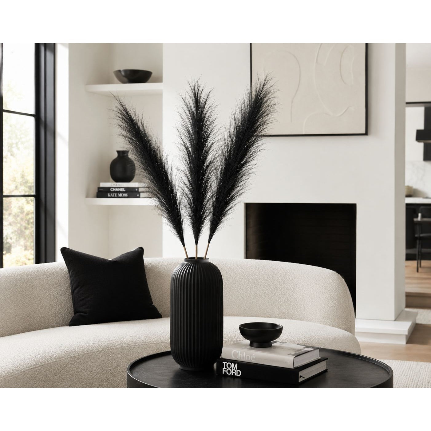 Living room with a vase of black feathers on a coffee table