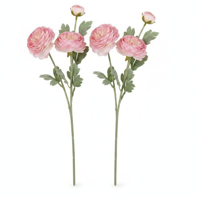Two artificial pink ranunculus flower stems with green leaves and buds, shown against a plain white background.