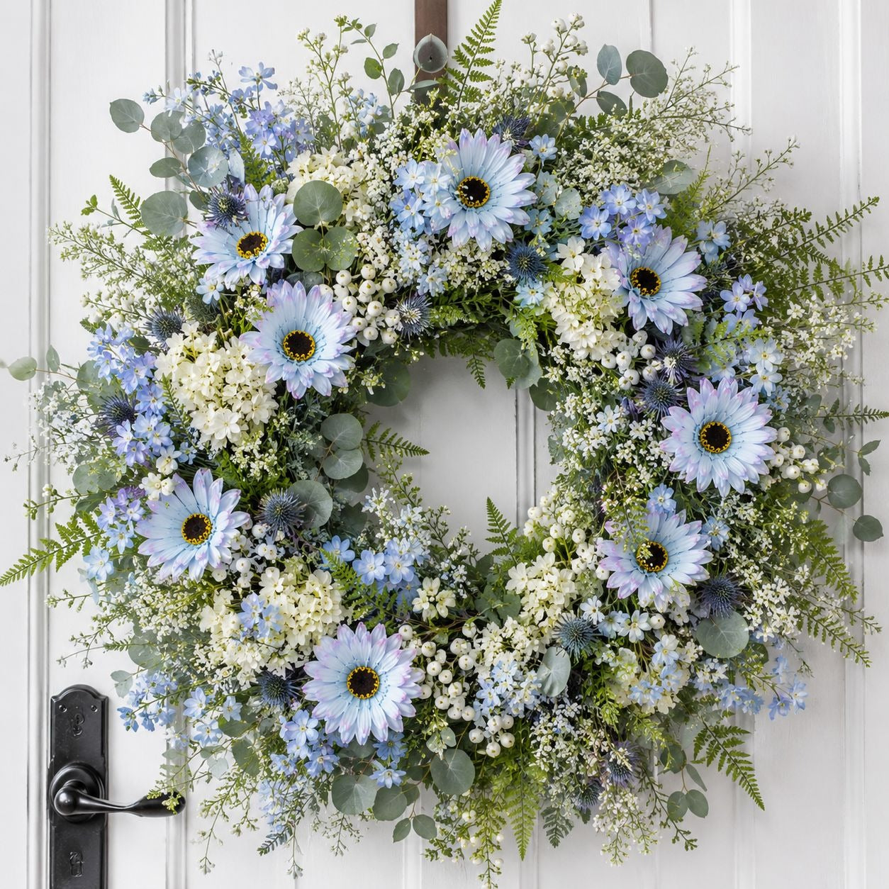 Floral wreath with blue and white flowers on a white door