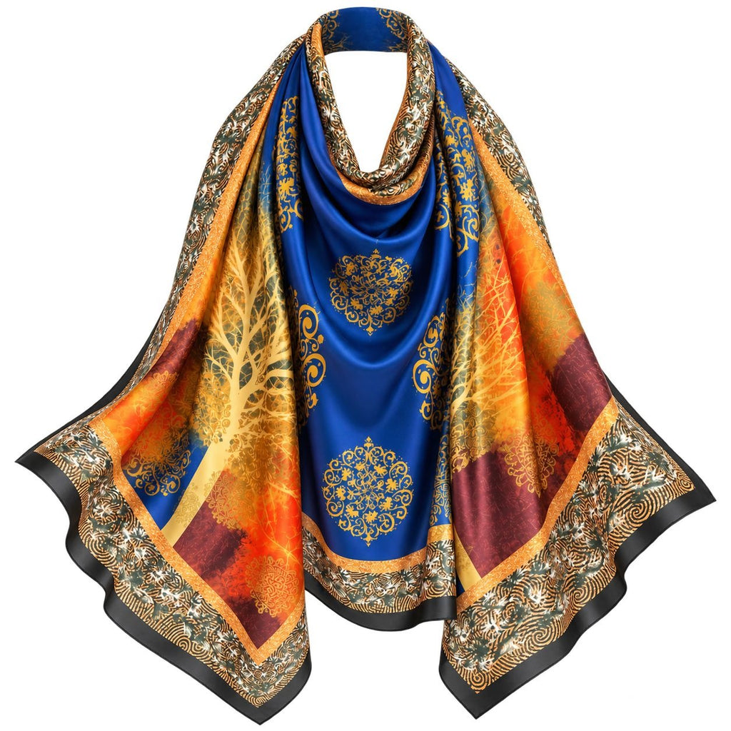 A silk-like scarf draped to display its pattern, featuring a royal blue center with gold mandala motifs, a golden tree design, and orange and burgundy sections, finished with an ornate gold and black border.