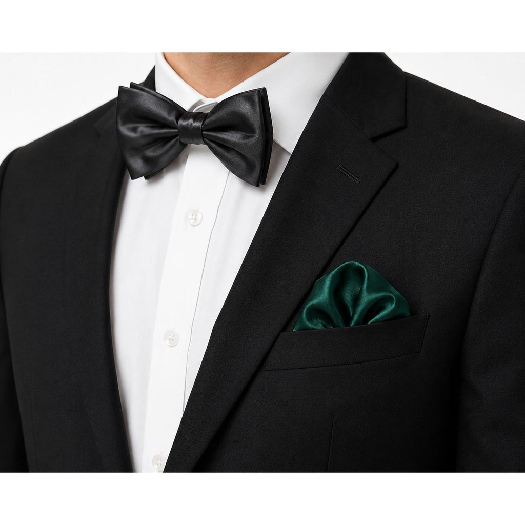 Black bow tie and green pocket square on a black suit jacket against a white background
