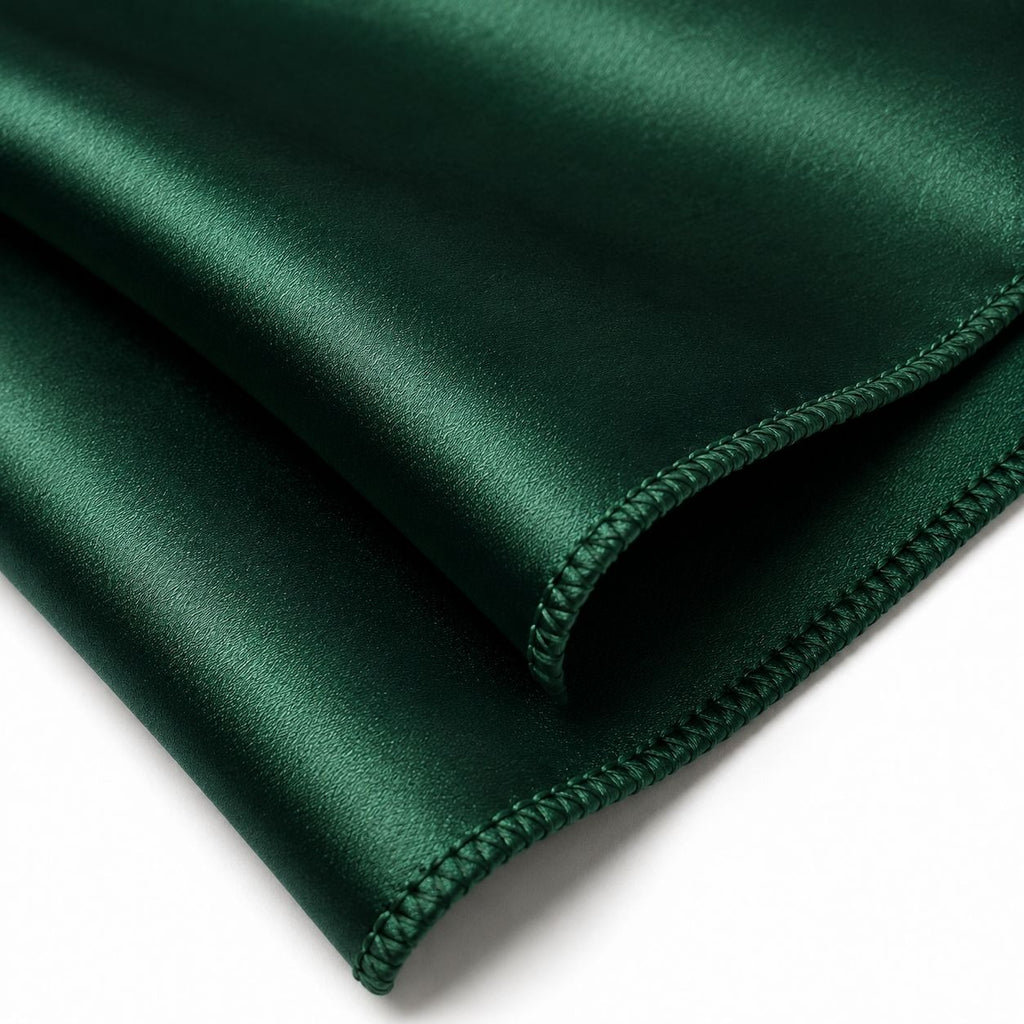 Dark green fabric with a folded edge on a white background