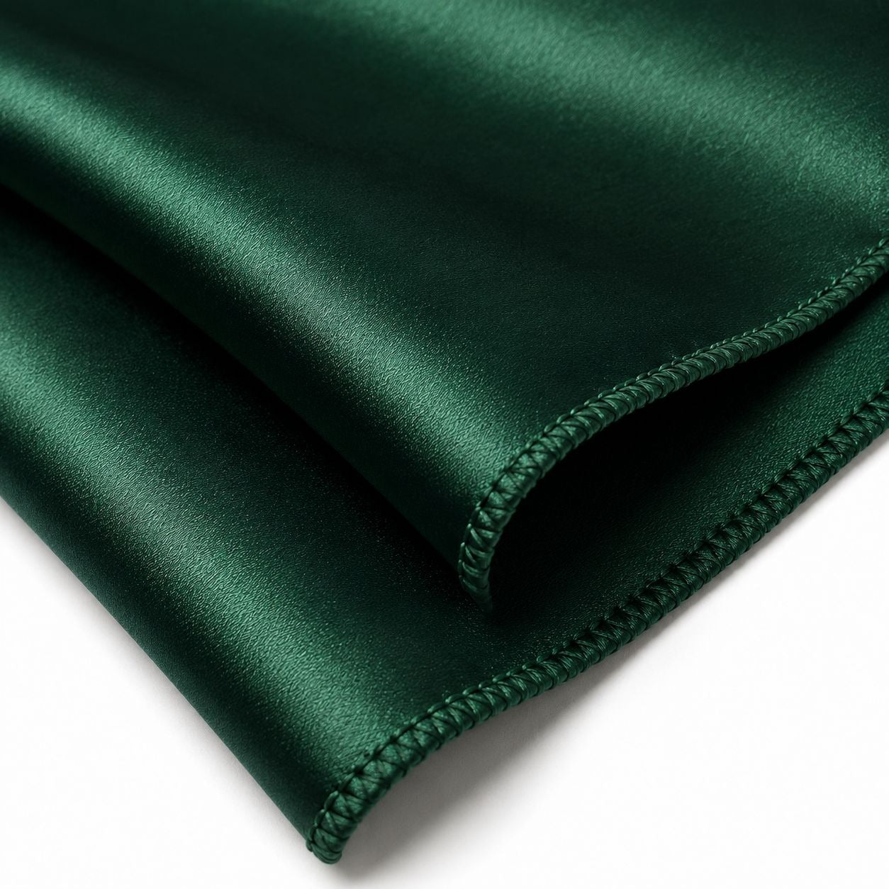 Dark green fabric with a folded edge on a white background