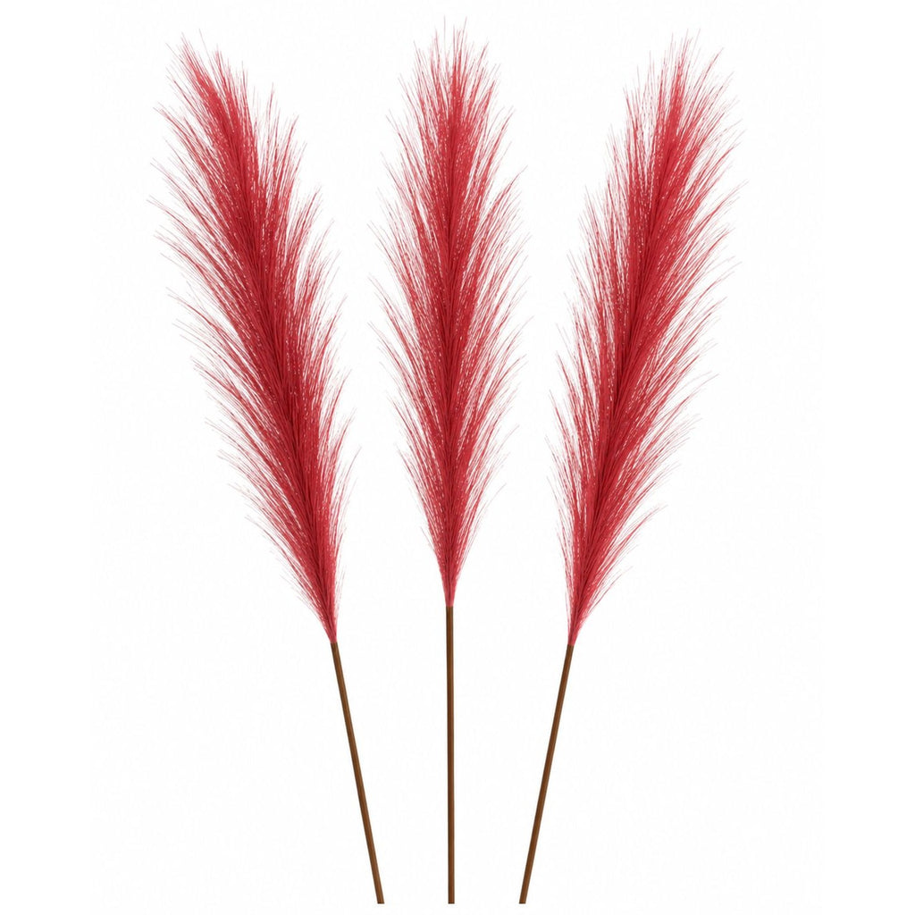 Three artificial red pampas grass stems with brown stems, arranged vertically against a plain white background.