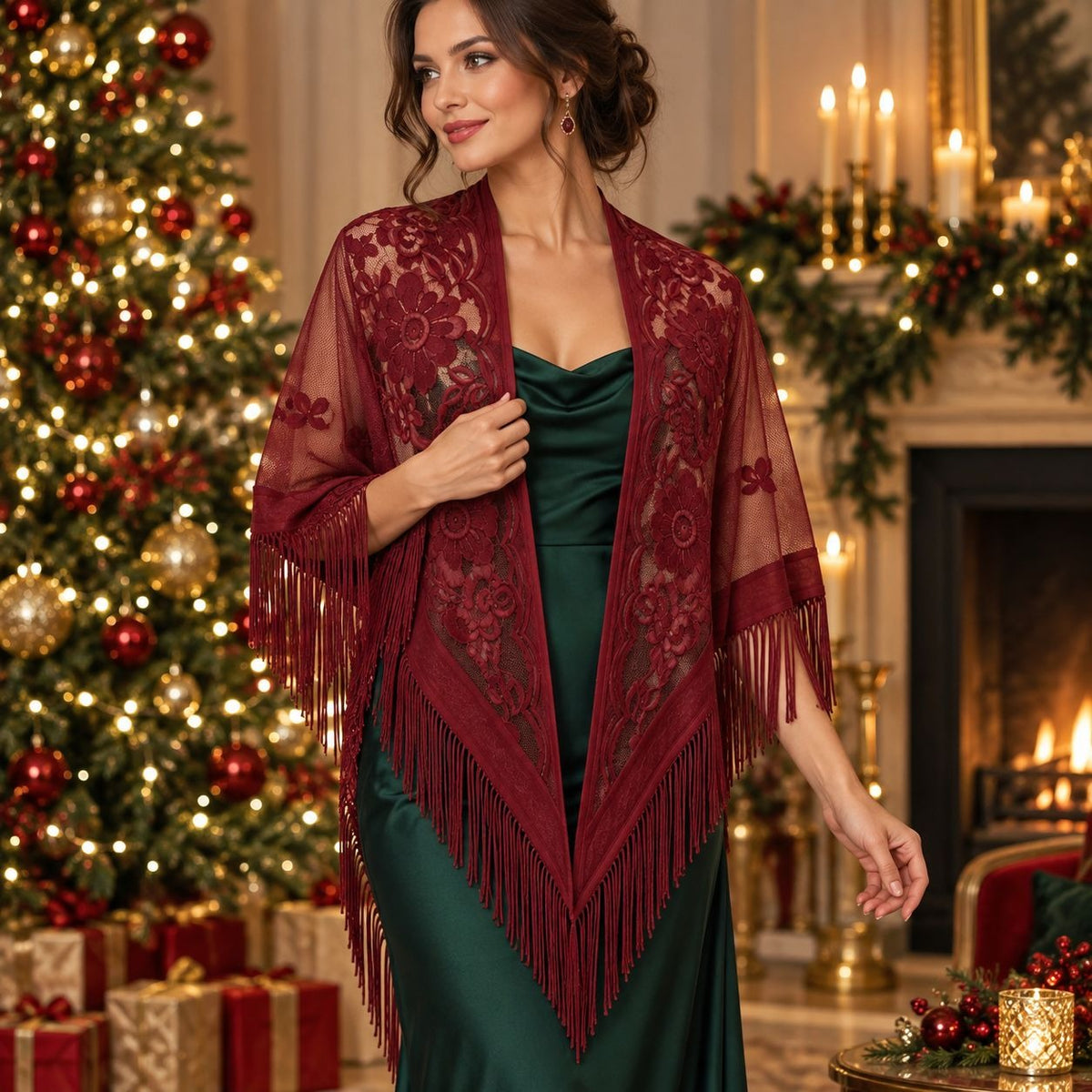 A woman stands in a decorated holiday room wearing a burgundy lace and fringe shawl over a dark green satin dress. A lit Christmas tree, fireplace, candles, and wrapped gifts are visible in the background.
