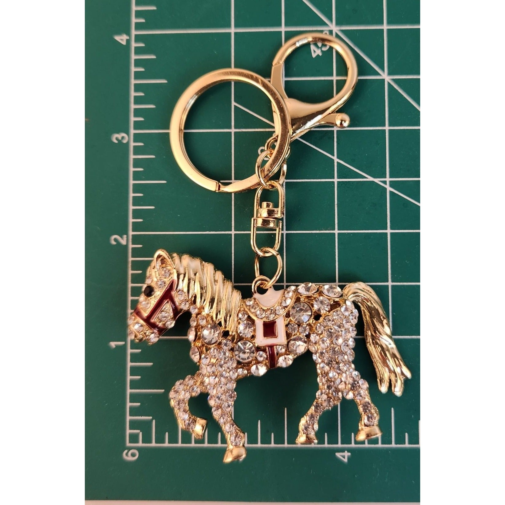 Rhinestone horse ornament showing intricate detailing and glossy gold finish