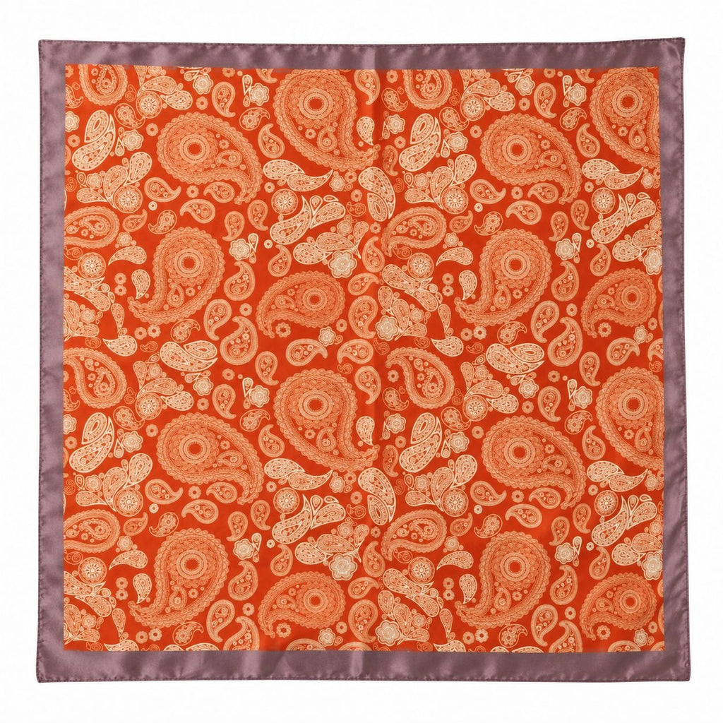 A square silk-like scarf featuring an all-over paisley pattern in orange and beige, finished with a contrasting mauve satin border.