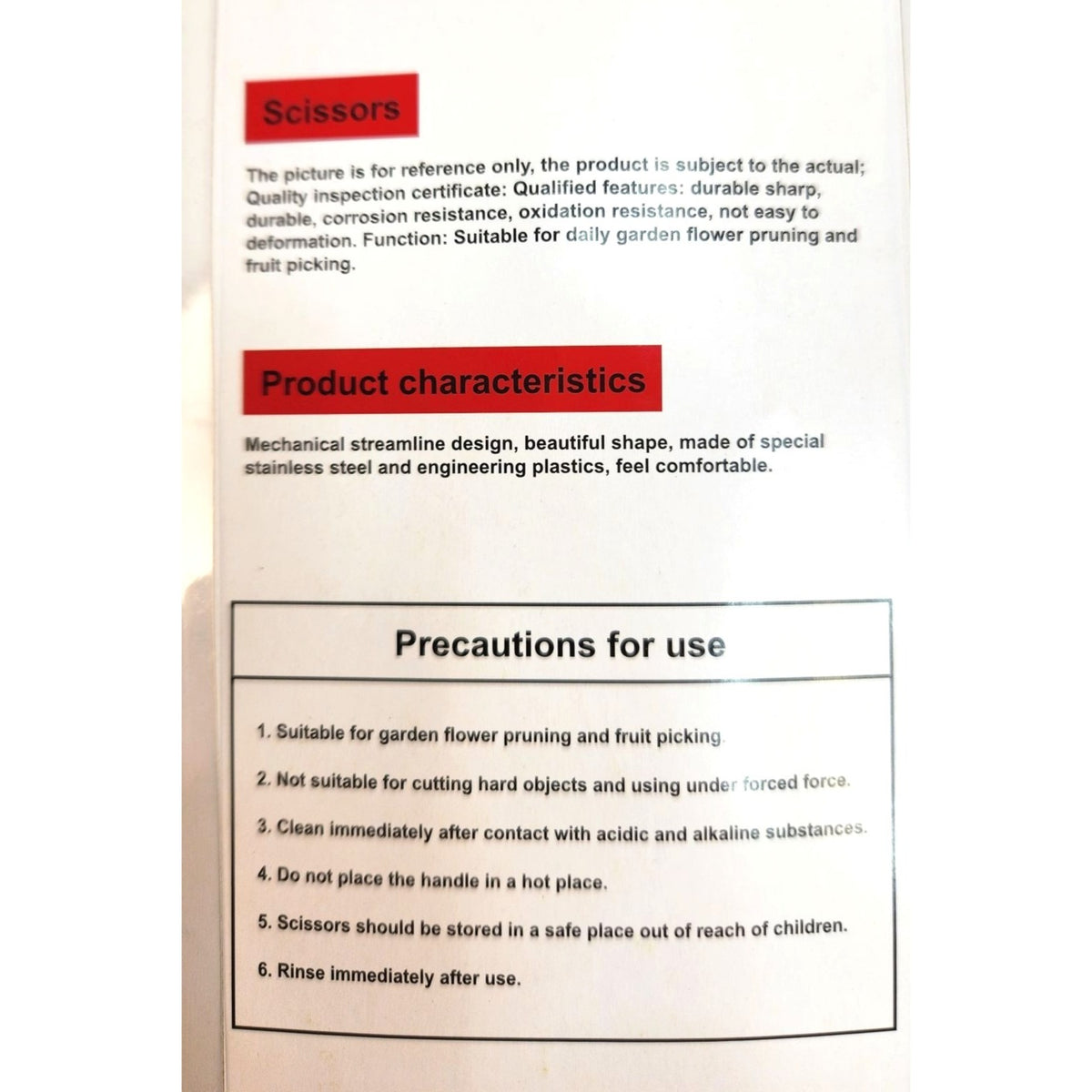 Close-up of the back of a product box showing printed text about scissors, including a 'Scissors' heading, product characteristics, and precautions for use.