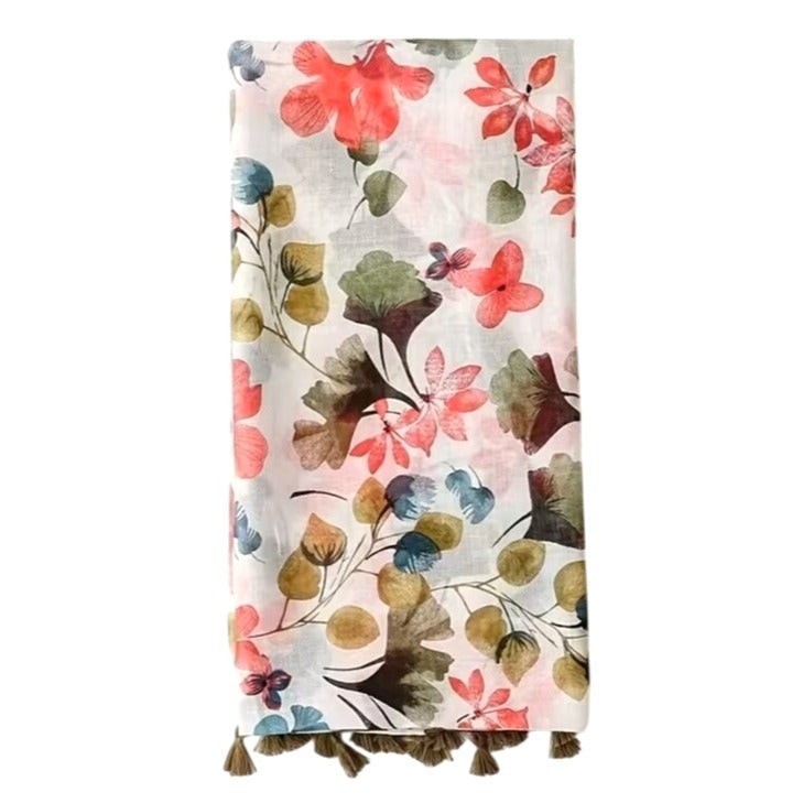 Floral patterned throw scarf with tassels on a white background