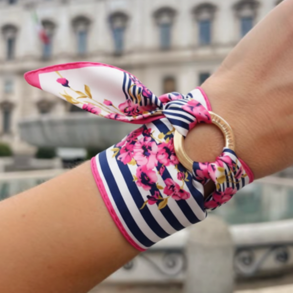 Close-up of pink navy floral satin square scarf double wrapped around wrist with gold ring bangle threaded through scarf knot wrist wrap jewelry styling 20x20