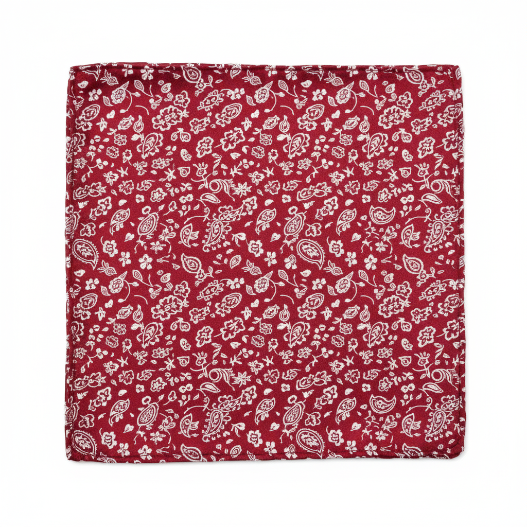 Close-up of top-left panel of red patchwork bandana scarf showing small floral paisley print in red and white satin