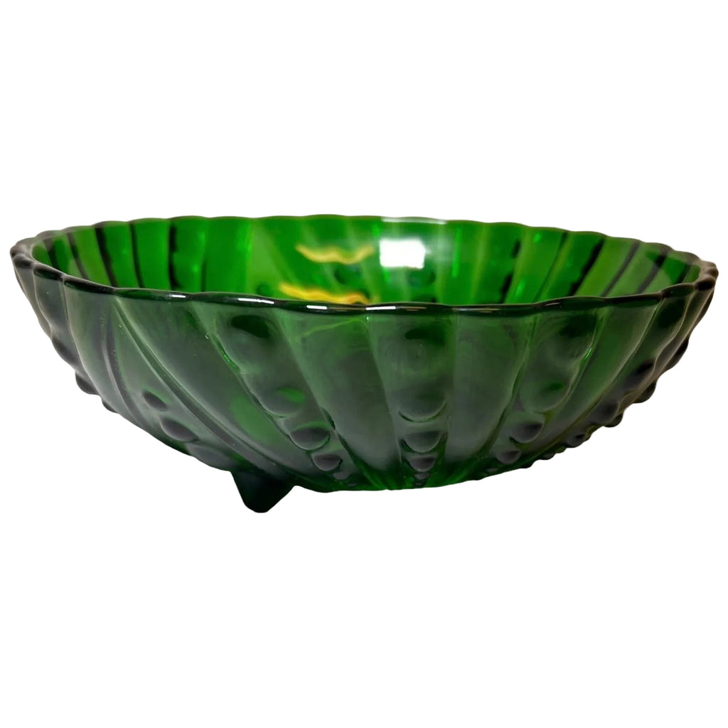 Green glass bowl with ribbed design on a white background