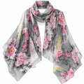 A lightweight, semi-sheer square scarf featuring a watercolor-style print of pink peonies, koi fish, and gray water scenery, draped against a solid white background.