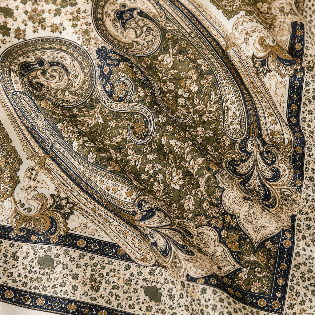 Close-up of an ornate scarf with intricate patterns and colors.