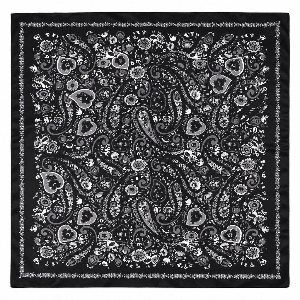 A square black bandana featuring an intricate white and gray paisley and floral pattern with a decorative border.
