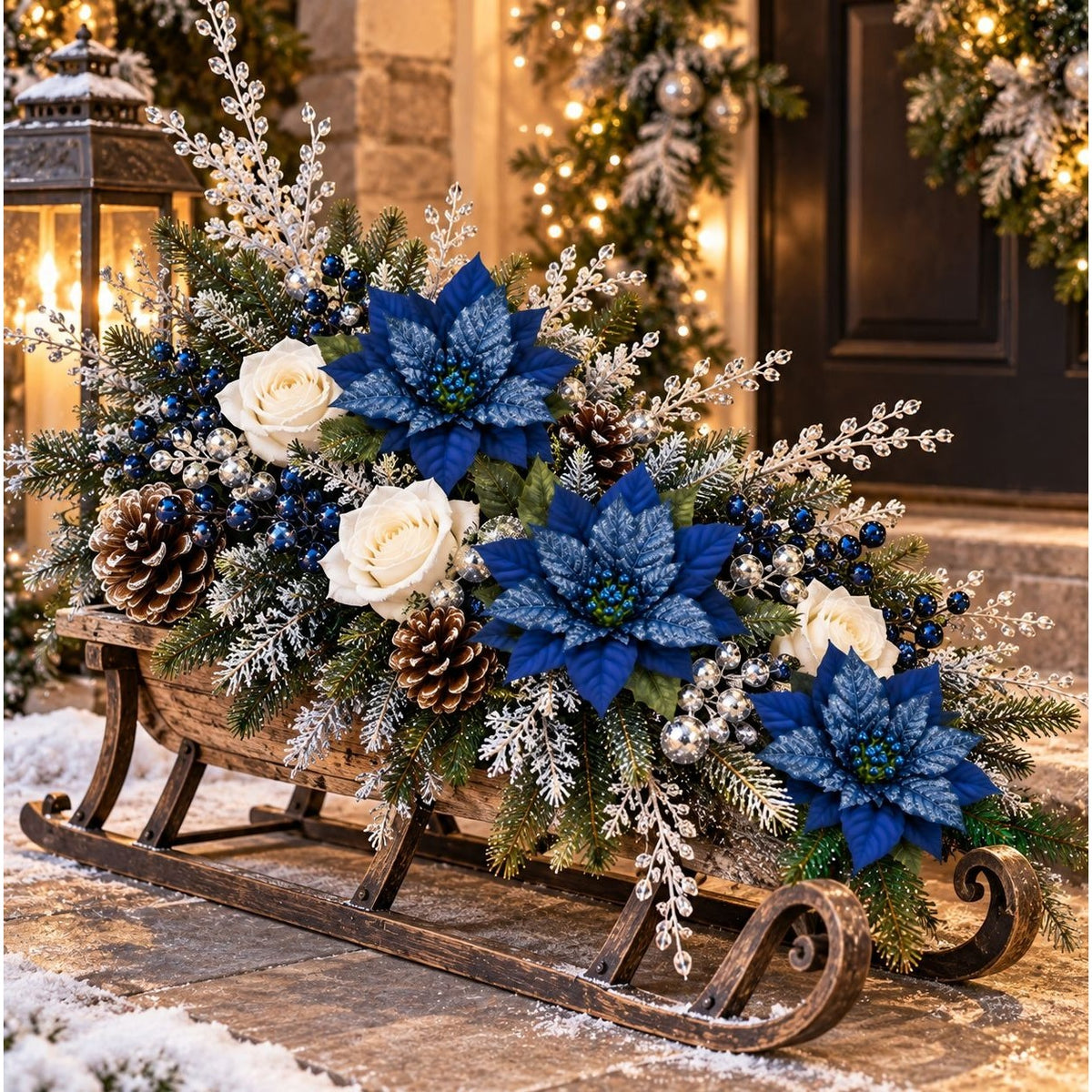 A festive winter floral arrangement in a rustic wooden sled centerpiece, decorated with blue poinsettias, white roses, pinecones, blue berries, and frosted greenery, set against a warmly lit holiday doorway.