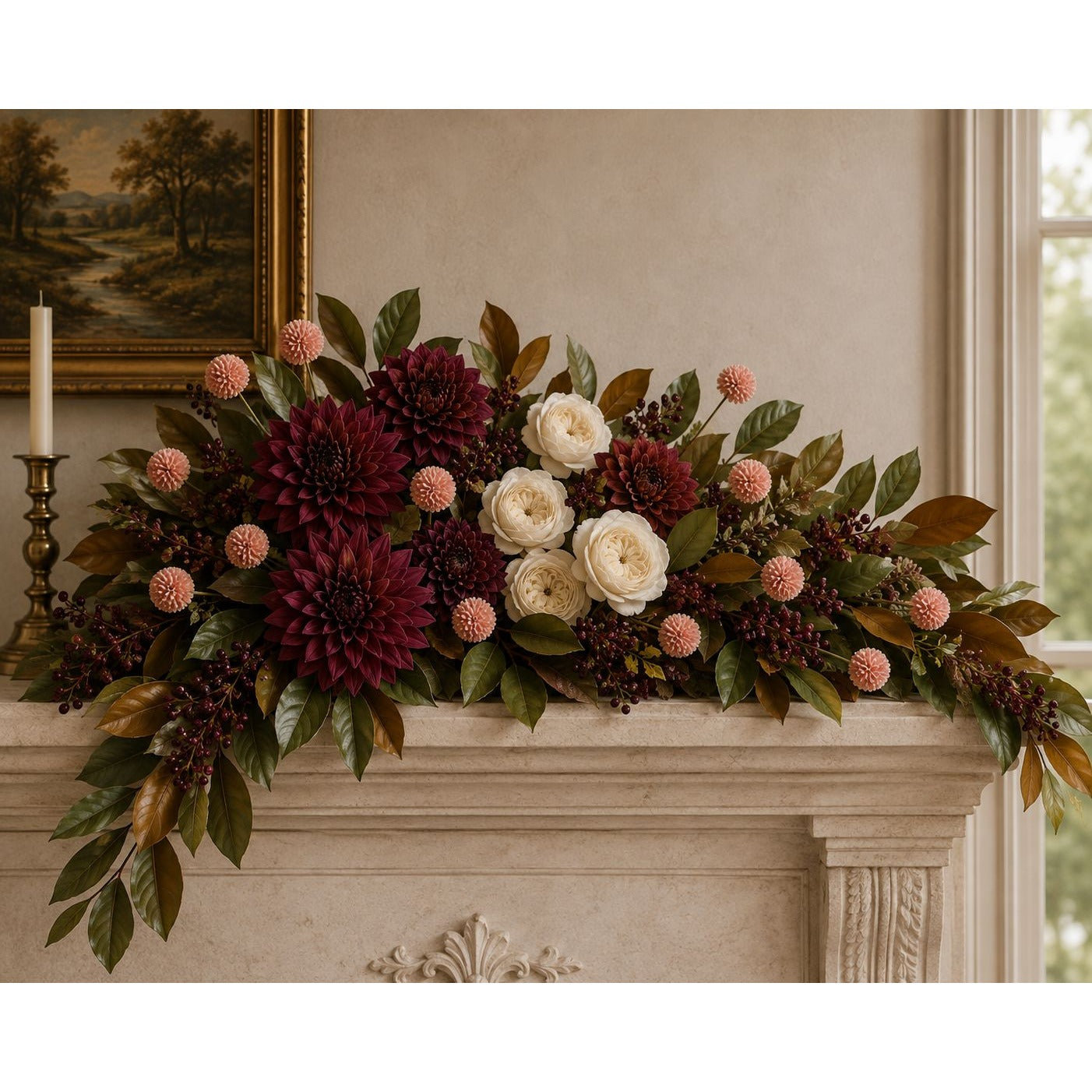 A large floral garland with burgundy dahlias, cream roses, green foliage, and pink pom-pom accents arranged across a stone fireplace mantel in an indoor room.