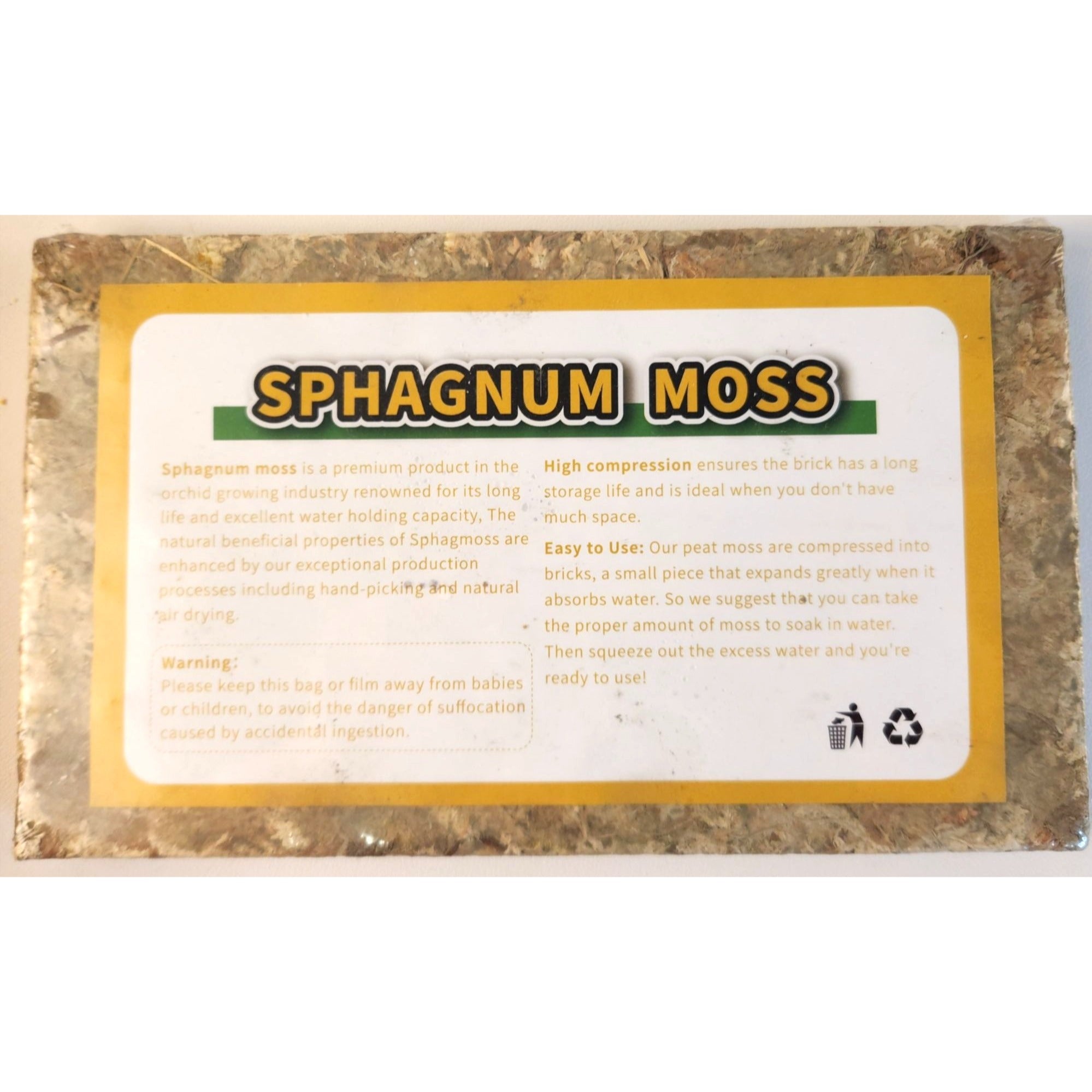 A rectangular package of compressed Sphagnum moss with a white label featuring yellow and green text, set against a plain white background.