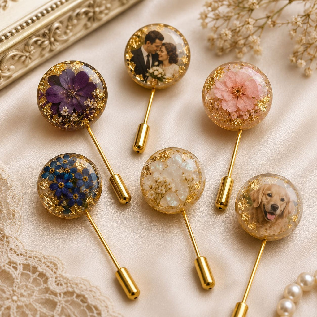Collection of decorative lapel pins with floral and portrait designs on a textured surface.