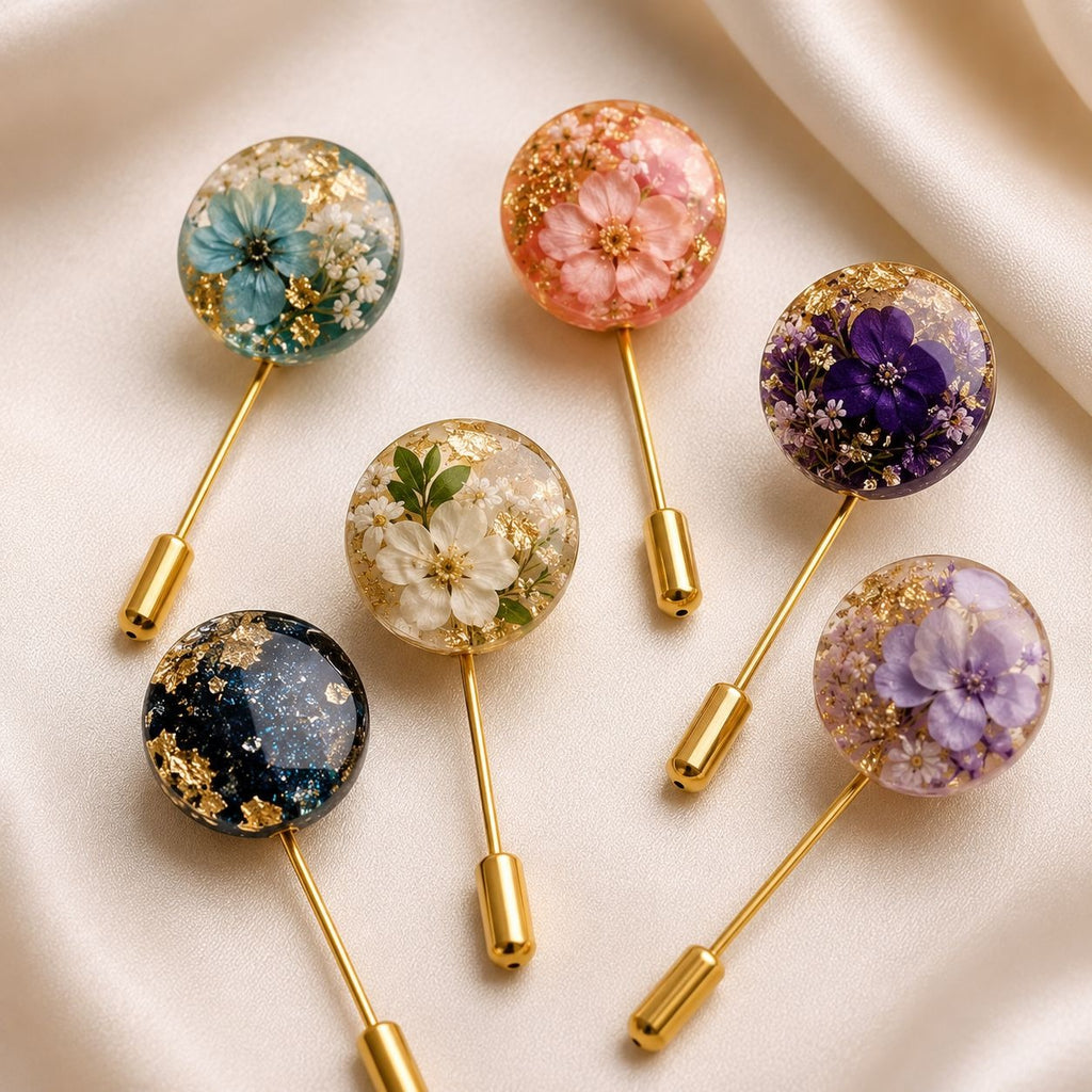 Set of floral brooches with gold sticks on a light background