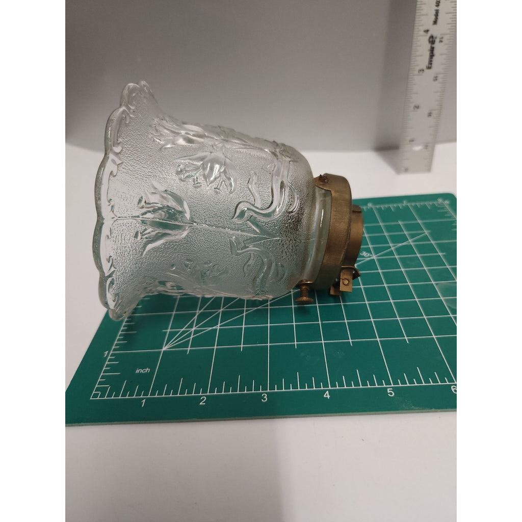 Metal set-screw fitter on vintage glass lamp shade showing mounting hardware