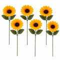 Six artificial sunflower stems with bright yellow petals, dark brown centers, and green leaves on a plain white background.